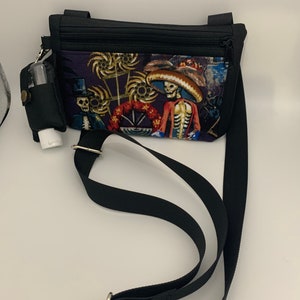 Calaveras cellphone crossbody bag with detachable hand sanitizer/lotion holder.