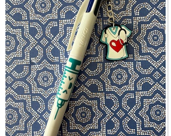 Four-color Bic pen with nurse/caregiver charm. Glossy varnish finish