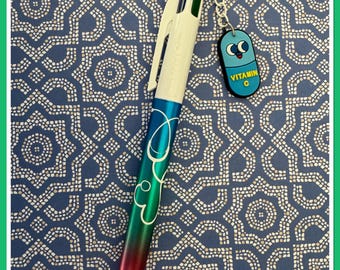 Four-color Bic pen with nurse/caregiver charm. Glossy varnish finish