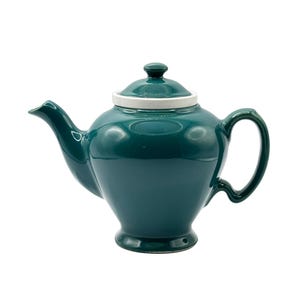 May include: A dark teal ceramic teapot with a glossy finish, featuring a rounded body, a curved spout, a C-shaped handle, and a matching lid with a white rim. The teapot sits on a pedestal base and has a smooth, reflective surface throughout.