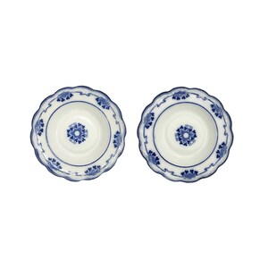 May include: Two white ceramic bowls with a blue floral design. The bowls have a scalloped edge and a detailed blue pattern around the rim and in the center. The bowls are set against a white background.