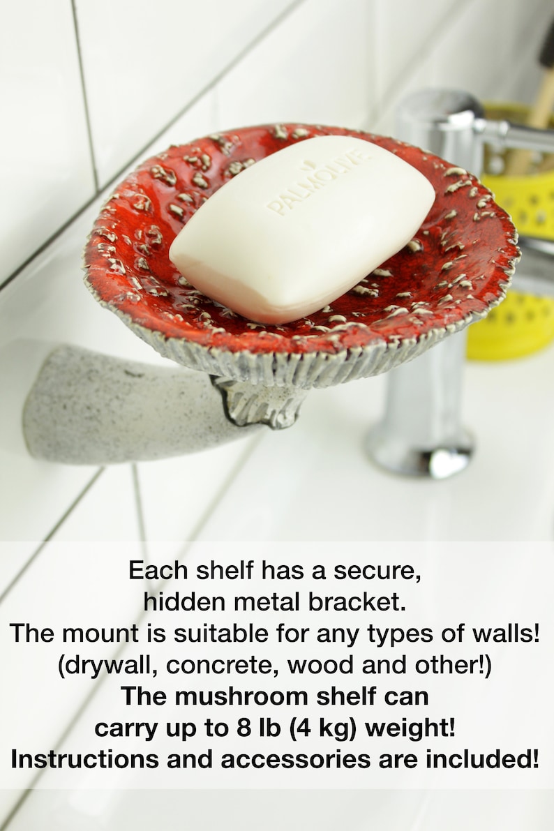 May include: A red and white ceramic mushroom-shaped soap dish with a white bar of soap on top. The dish is mounted to a wall with a hidden metal bracket. The text "PALMOLIVE" is visible on the soap bar. The caption below the dish reads "Each shelf has a secure, hidden metal bracket. The mount is suitable for any types of walls! (drywall, concrete, wood and other!) The mushroom shelf can carry up to 8 lb (4 kg) weight! Instructions and accessories are included!"