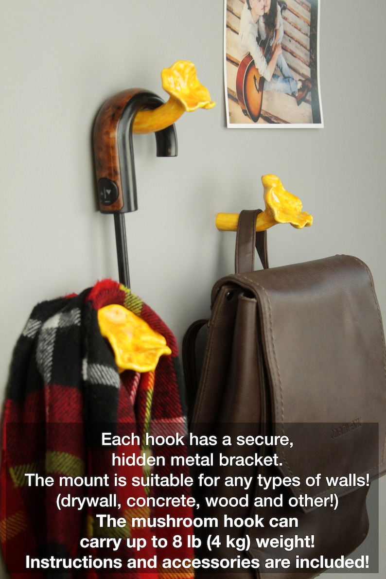May include: Three yellow ceramic mushroom hooks mounted on a wall. Each hook has a secure hidden metal bracket. The hooks are holding a scarf, a backpack, and an umbrella. The text on the image reads: "Each hook has a secure, hidden metal bracket. The mount is suitable for any types of walls! (drywall, concrete, wood and other!) The mushroom hook can carry up to 8 lb (4 kg) weight! Instructions and accessories are included!"