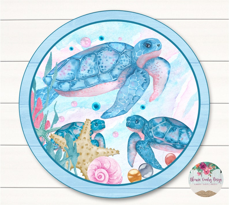 May include: A blue and pink watercolor illustration of three sea turtles swimming in the ocean. The turtles are surrounded by bubbles, seaweed, and seashells. The background is a light blue watercolor wash.
