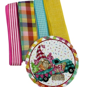 May include: A set of four colorful ribbon rolls with a round, colorful, printed card featuring a gnome driving a truck with ice cream cones. The card says "ICE CREAM".