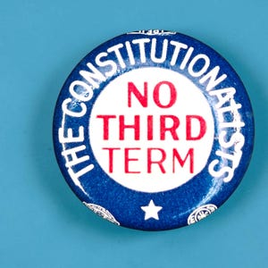 May include: A round political pinback button featuring a blue border with the white text THE CONSTITUTIONALISTS and a white center with the red text NO THIRD TERM. A small white star is positioned at the bottom of the blue border area.