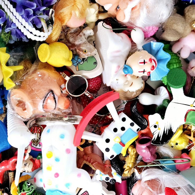 May include: A collection of colorful and whimsical toys, including a rocking horse, a doll, a rocking chair, and a variety of other small toys. The toys are made of plastic, wood, and fabric.