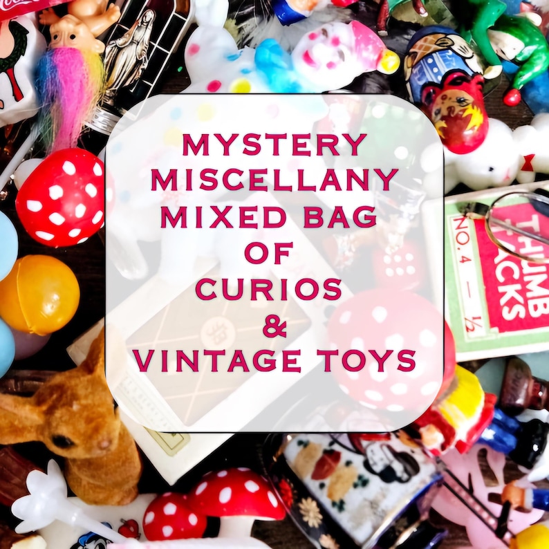 May include: A close-up of a variety of vintage toys and curios, including a small stuffed bunny, a white plastic toy, a red and white polka dot ball, and a small wooden toy. The image is labeled "MYSTERY MISCELLANY MIXED BAG OF CURIOS & VINTAGE TOYS".
