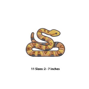 May include: An embroidered patch shaped like a coiled snake with a pattern of alternating brown and yellow segments. The design features dark grey outlines and textured stitching. The text below the snake reads 11 Sizes: 2 - 7 inches.