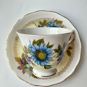 Beautiful Queen Anne Bone China Blue Daisy Teacup and Saucer with Purple and Yellow Vintage Florals Made in England Tea party Cottage Core