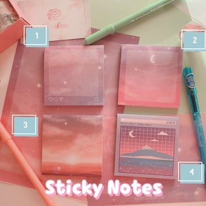 May include: Set of four pastel pink and blue sticky notes with different designs. The notes feature a moon, clouds, a mountain, and a heart. The notes are labelled 1-4. The text "Sticky Notes" and "Art by SilverRose" is printed on the bottom of the image.