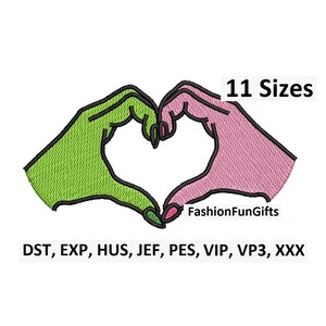 May include: An embroidered design featuring two hands forming a heart shape. One hand is green, the other is pink, with black outlines. The text "11 Sizes" is above the heart, and "FashionFunGifts" is below. The design includes various file formats.
