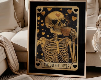 May include: Framed art print featuring a skeleton with heart-shaped sunglasses, holding a coffee cup. The skeleton is gold-toned against a black background with gold hearts. The text "THE COFFEE LOVER" is at the bottom. The frame is gold.