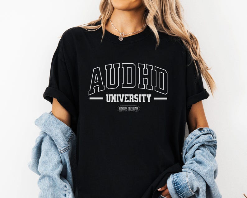 May include: Black t-shirt with white text that reads "AUDHD UNIVERSITY HONORS PROGRAM".