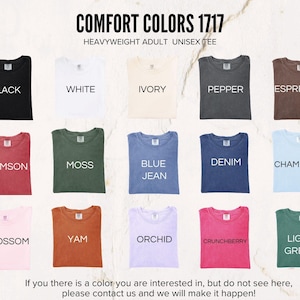 May include: A display of various Comfort Colors 1717 heavyweight adult unisex tees in multiple colors. Colors include black, white, ivory, pepper, espresso, crimson, moss, blue jean, denim, chambray, blossom, yam, orchid, crunchberry, and light green.