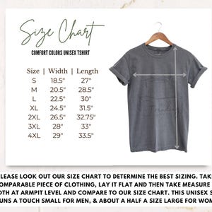 May include: Size chart for a unisex t-shirt with measurements in inches. The chart shows the width and length of the shirt in sizes S, M, L, XL, 2XL, 3XL, and 4XL. The text "Comfort Colors Unisex T-shirt" is at the top of the chart.