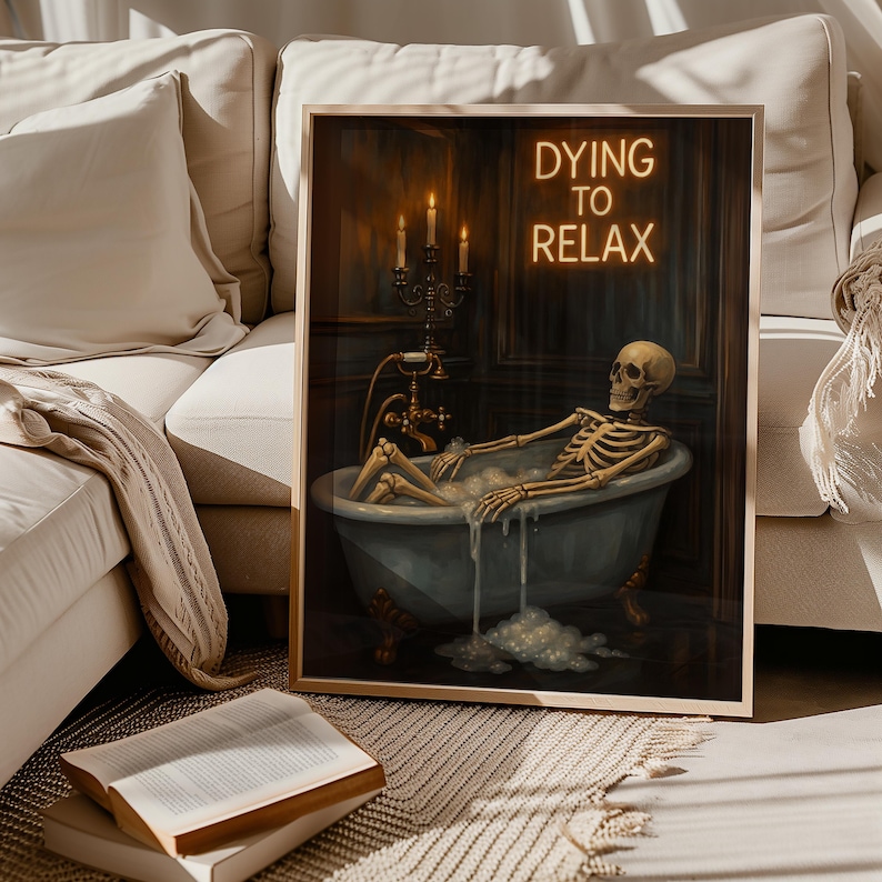 May include: Framed art print featuring a skeleton relaxing in a bathtub filled with bubbles. The artwork has a vintage aesthetic with a dark color palette. The text "DYING TO RELAX" is displayed in neon-style lettering above the tub.