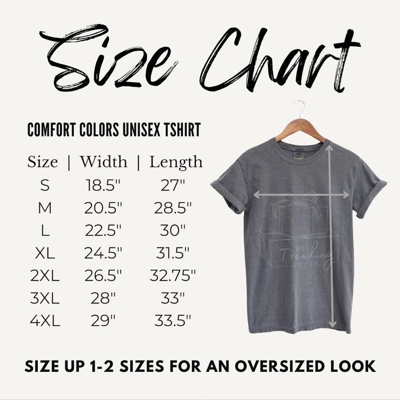 Puede incluir: Una tabla de tallas para una camiseta unisex Comfort Colors, con medidas en pulgadas para las tallas S a 4XL. La tabla incluye las dimensiones de ancho y largo. La imagen tambi&eacute;n muestra una camiseta gris en una percha.