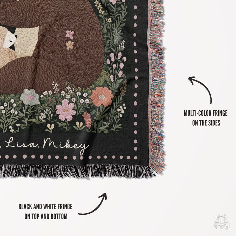 May include: Black and white throw blanket with a floral design and two bears hugging. The blanket has a black and white fringe on the top and bottom and a multi-colour fringe on the sides. The blanket has the text "Lisa. Mikey" on it.