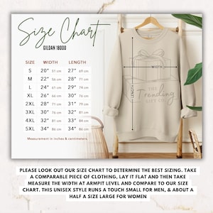 May include: Size chart for Gildan 18000 sweatshirts, showing width and length measurements in inches and centimeters for sizes S through 5XL. The chart includes a graphic of a sweatshirt with a gift box design and the text "The Trending Gift Co."