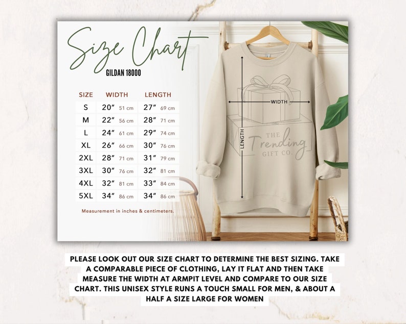 May include: Size chart for Gildan 18000 sweatshirts, showing width and length measurements in inches and centimeters for sizes S through 5XL. The chart includes a graphic of a sweatshirt with a gift box design and the text "The Trending Gift Co."