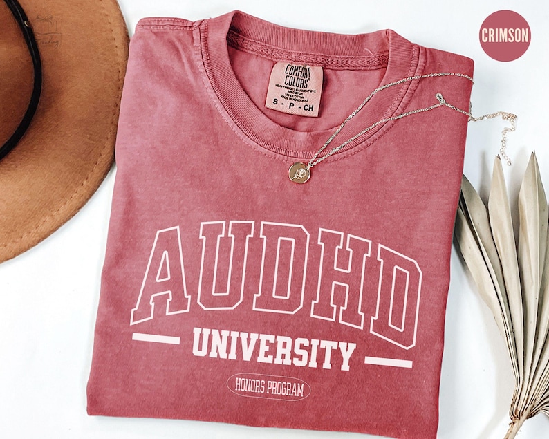 May include: Crimson red t-shirt with white text that reads "ADHD University - Honours Program".