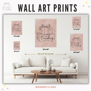 May include: Wall art prints featuring line drawings of gift boxes with bows, in various sizes. The largest print is 30"x40", with other sizes including 16"x20", 18"x24", 11"x14", and 9"x11". The prints are displayed above a white sofa.