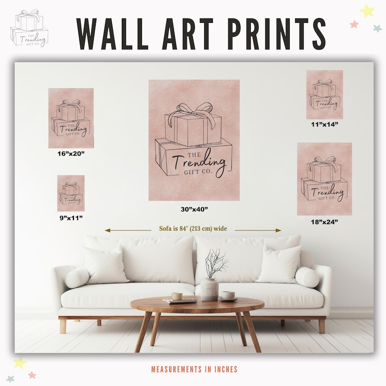 May include: Wall art prints featuring line drawings of gift boxes with bows, in various sizes. The largest print is 30"x40", with other sizes including 16"x20", 18"x24", 11"x14", and 9"x11". The prints are displayed above a white sofa.