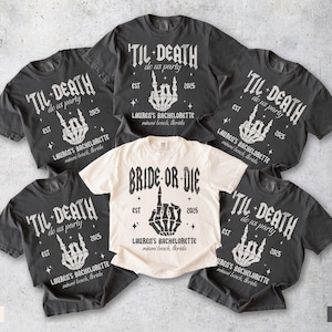 May include: A collection of ivory and pepper-colored t-shirts. The shirts feature the text "'TIL DEATH do us party" and "BRIDE OR DIE" with a skeleton hand graphic. The text "LAUREN'S BACHELORETTE" and the year "2025" are also printed on the shirts.