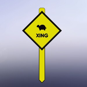 May include: A yellow diamond-shaped road sign with a black border and a black turtle silhouette. The sign reads "XING" in black letters.