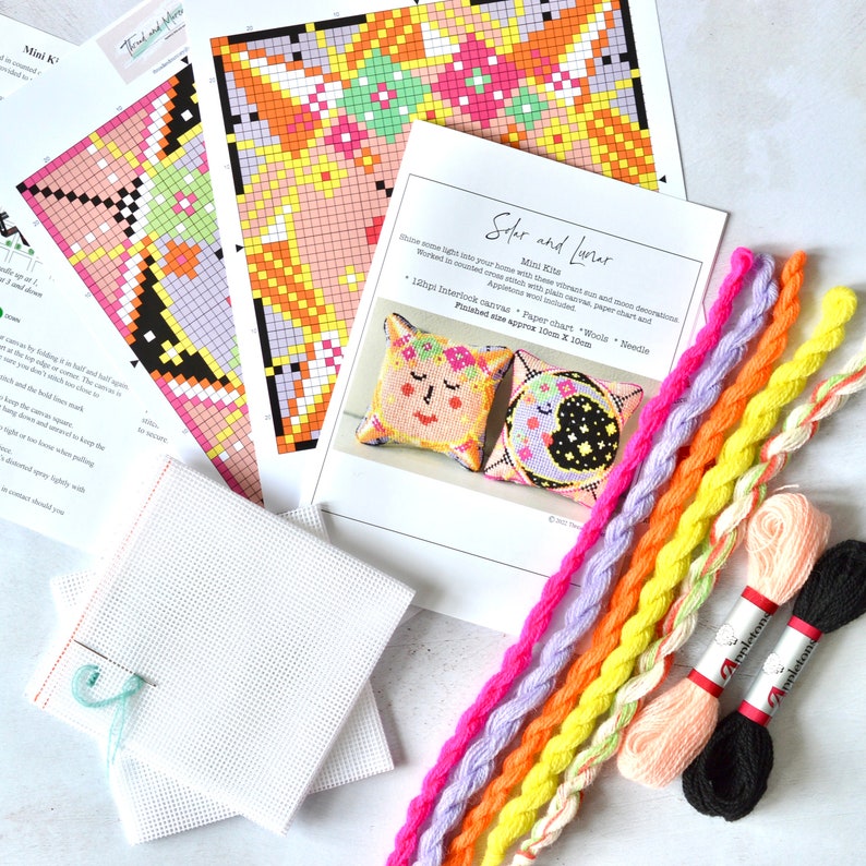 May include: A craft kit with instructions, colorful thread, and canvas. The kit includes a paper chart and needle. The instructions are for a cross-stitch project with a sun and moon design. The finished size is approximately 10cm x 10cm.