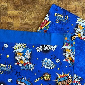 Placemats for kids: Sonic, Elsa, Anna and other cartoon characters including Woody, Buzz, Martian,  Lion, Cat. See item details.