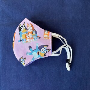 Bluey Face Mask for Child or Toddler: 2-Layer Cotton. Colors available are Blue and Pink. Also baby bib and tote bag. image 11