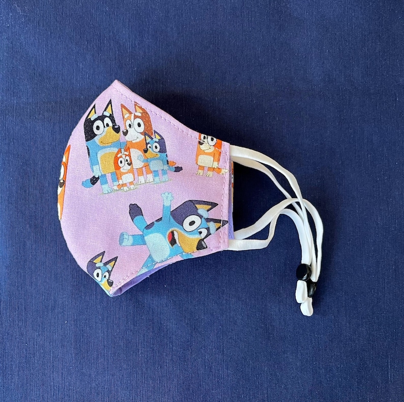 Bluey Face Mask for Child or Toddler: 2-Layer Cotton. Colors available are Blue and Pink. Also baby bib and tote bag. image 11
