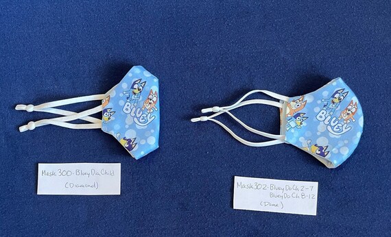 Bluey Face Mask for Child or Toddler: 2-Layer Cotton. Colors available are Blue and Pink. Also baby bib and tote bag.