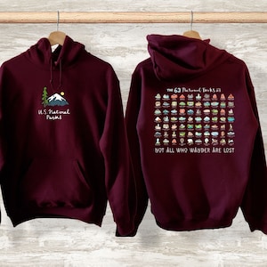 May include: Burgundy hoodie with a graphic of a mountain and a tree on the front and a graphic of the 63 National Parks with the text "The 63 National Parks" and "Not all who wander are lost" on the back.