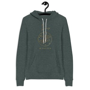 May include: A dark green hoodie with a gold Pisces zodiac symbol and the word "Pisces" printed on the front.