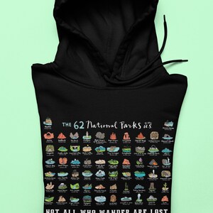 May include: Black hooded sweatshirt with a white graphic of the 62 National Parks of the U.S. with the text "Not all who wander are lost".