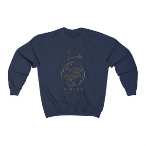 May include: Navy blue sweatshirt with a gold outline of the Pisces zodiac sign and the word "Pisces" printed below.