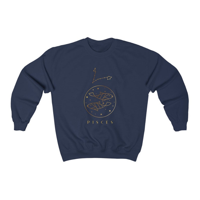May include: Navy blue sweatshirt with a gold outline of the Pisces zodiac sign and the word "Pisces" printed below.