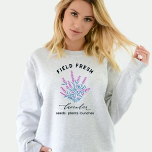 May include: Gray sweatshirt with a graphic of lavender flowers and the text "FIELD FRESH lavender seeds. plants. bunches"