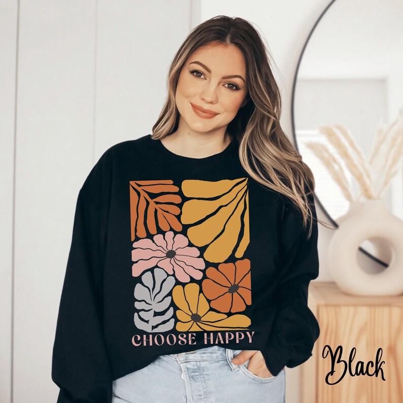 May include: Black sweatshirt with a colorful floral design and the text "Choose Happy".