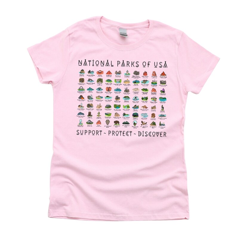 May include: Pink women's t-shirt with a graphic of all the National Parks of the USA. The graphic includes the name of each park and a small illustration of a landmark from each park. The text "SUPPORT - PROTECT - DISCOVER" is printed below the graphic.