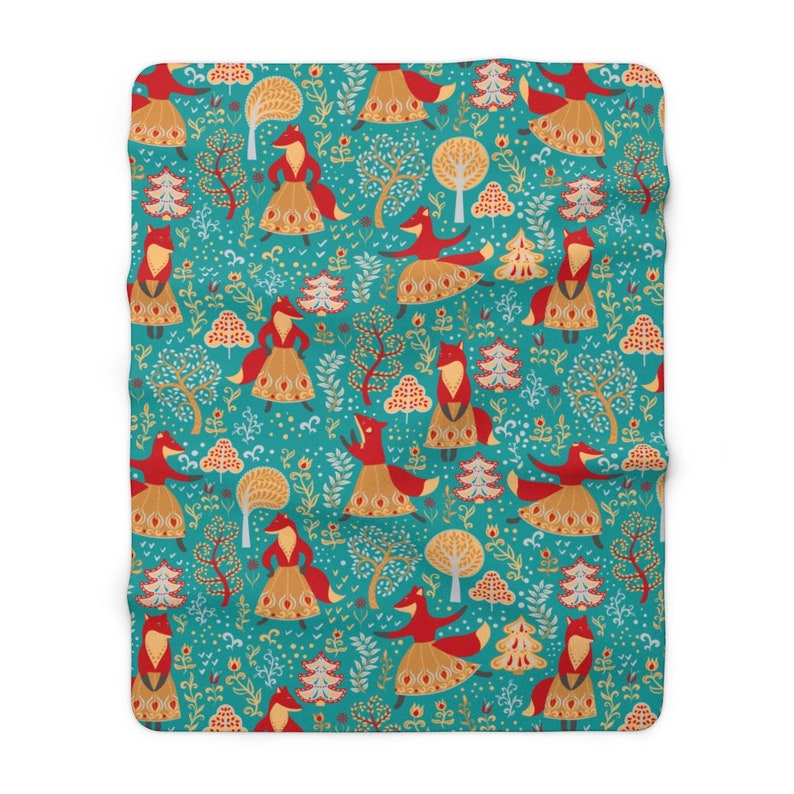 May include: Teal blue fabric with a repeating pattern of red foxes wearing gold skirts and dancing in a forest. The forest is filled with trees, flowers, and leaves.