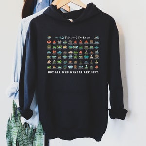 May include: Black hooded sweatshirt with a graphic of the 62 National Parks in the United States. The graphic is a colorful illustration of each park's iconic landmark. The text "THE 62 National Parks" is at the top of the graphic, and the text "NOT ALL WHO WANDER ARE LOST" is at the bottom.