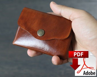 May include: A brown leather wallet with a flap closure and a metal button. The wallet is being held in a hand.