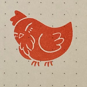 May include: A red chicken illustration with a white outline on a white background with small black dots.