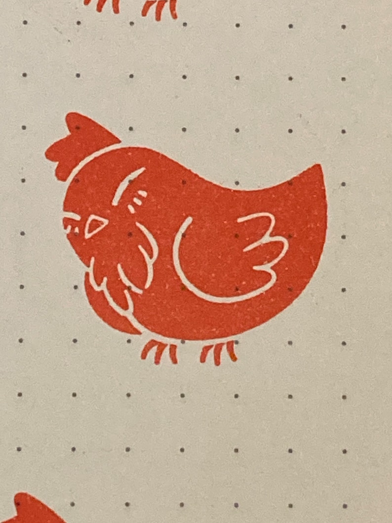 May include: A red chicken illustration with a white outline on a white background with small black dots.