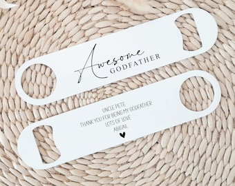 May include: Two white metal bottle openers with a black inscription. The top opener says "Awesome Godfather". The bottom opener says "Uncle Pete Thank you for being my Godfather Lots of love Abigail" with a small heart.
