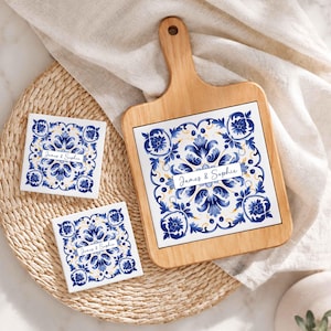 May include: A wooden chopping board and two square coasters with a blue and white floral design. The board has a handle and a white tile insert with the names "James & Sophie". The coasters also feature the names.